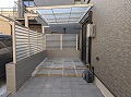 外構で世田谷区のO様邸現場を施工した画像で屋根付きで石貼りテラスの施工例・隣地との境はブロックに目隠しフェンスを設置しました