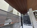 世田谷区の外構工事で駐輪場奥に黒い物置を設置した施工画像